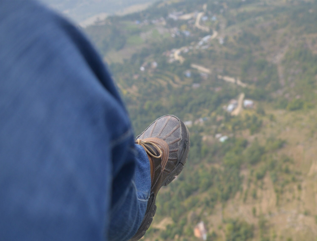 Eddie's boot dangling above the Pokhara valley far below