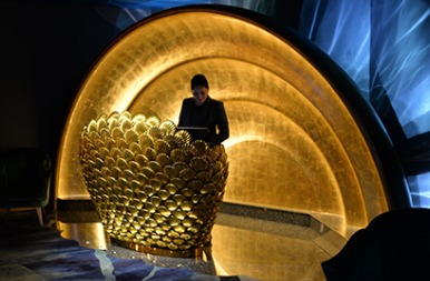 Al Mahara desk carved with a shell motif beside the aquarium