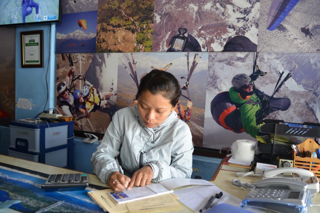 The Frontiers Paragliding office in Pokhara, walls covered in paragliding posters